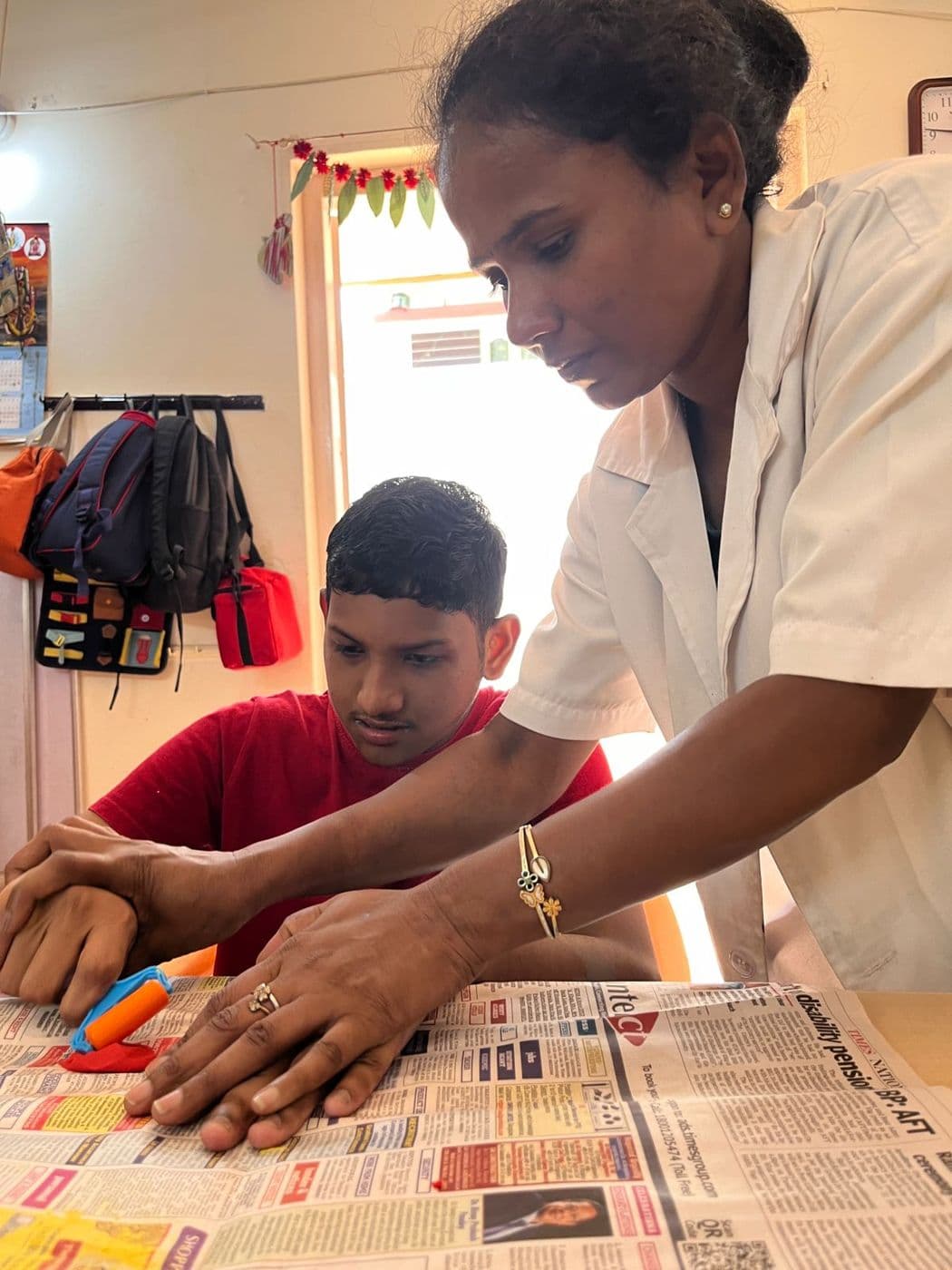 Newspaper craft with a teacher's help